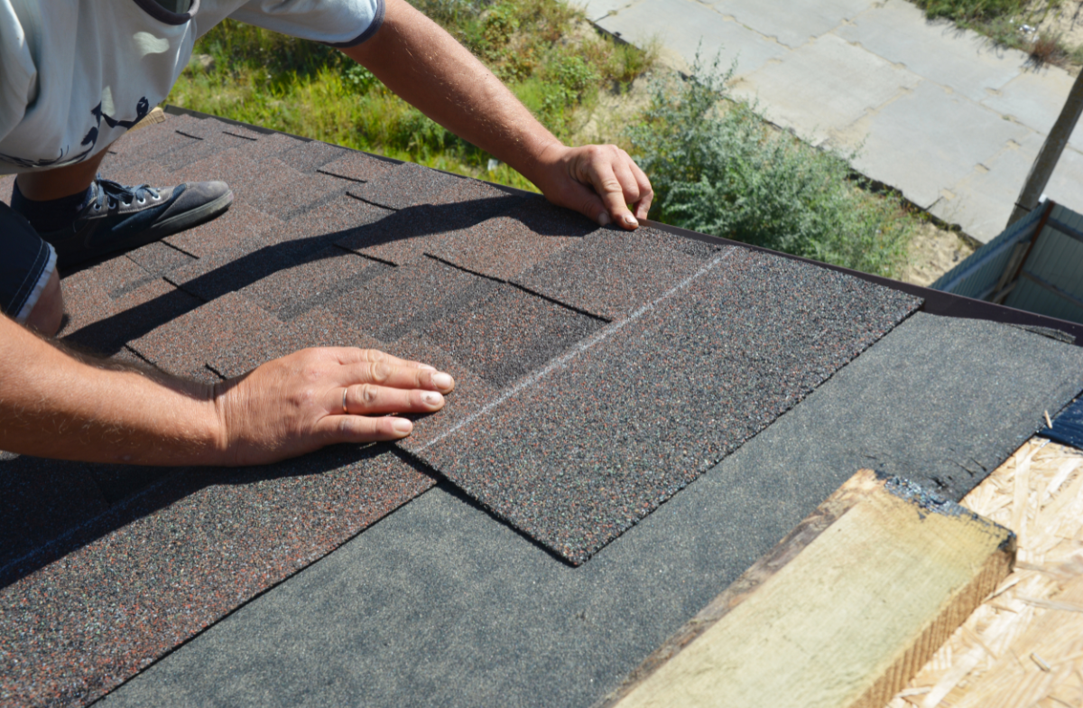 Skilled craftsman hands installing premium roofing materials with precision and attention to detail