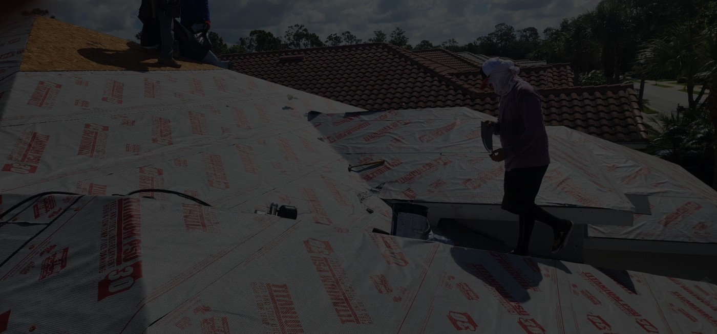 Professional roofer installing high-quality underlayment system as foundation for tile roofing