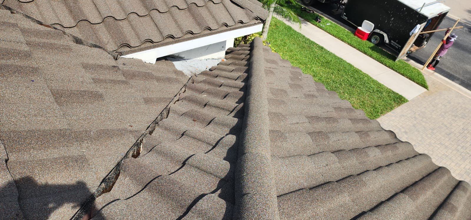 Before photo showing damaged roofing requiring professional repair and replacement services
