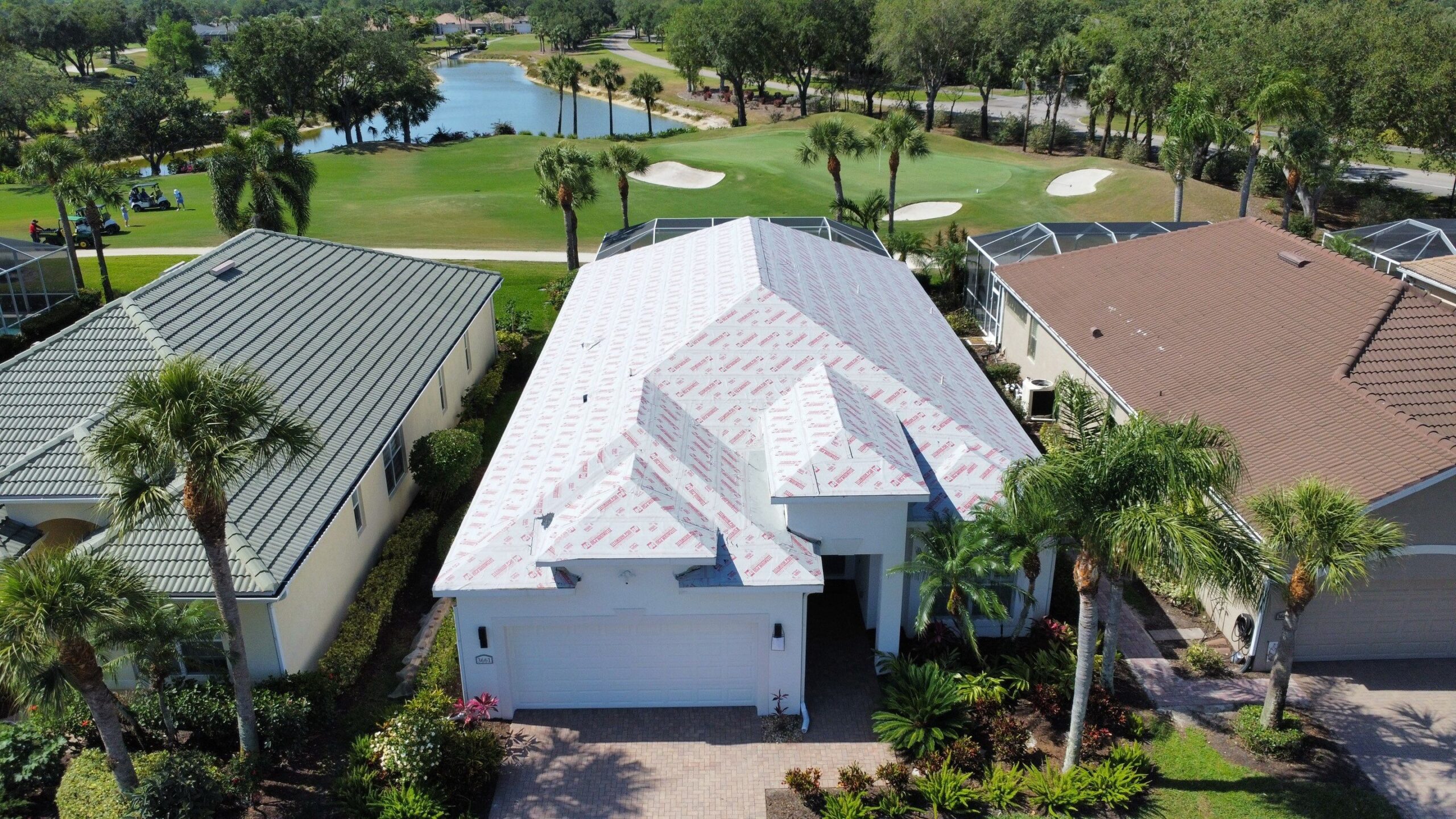 Luxury golf course community homes with premium roofing systems aerial view