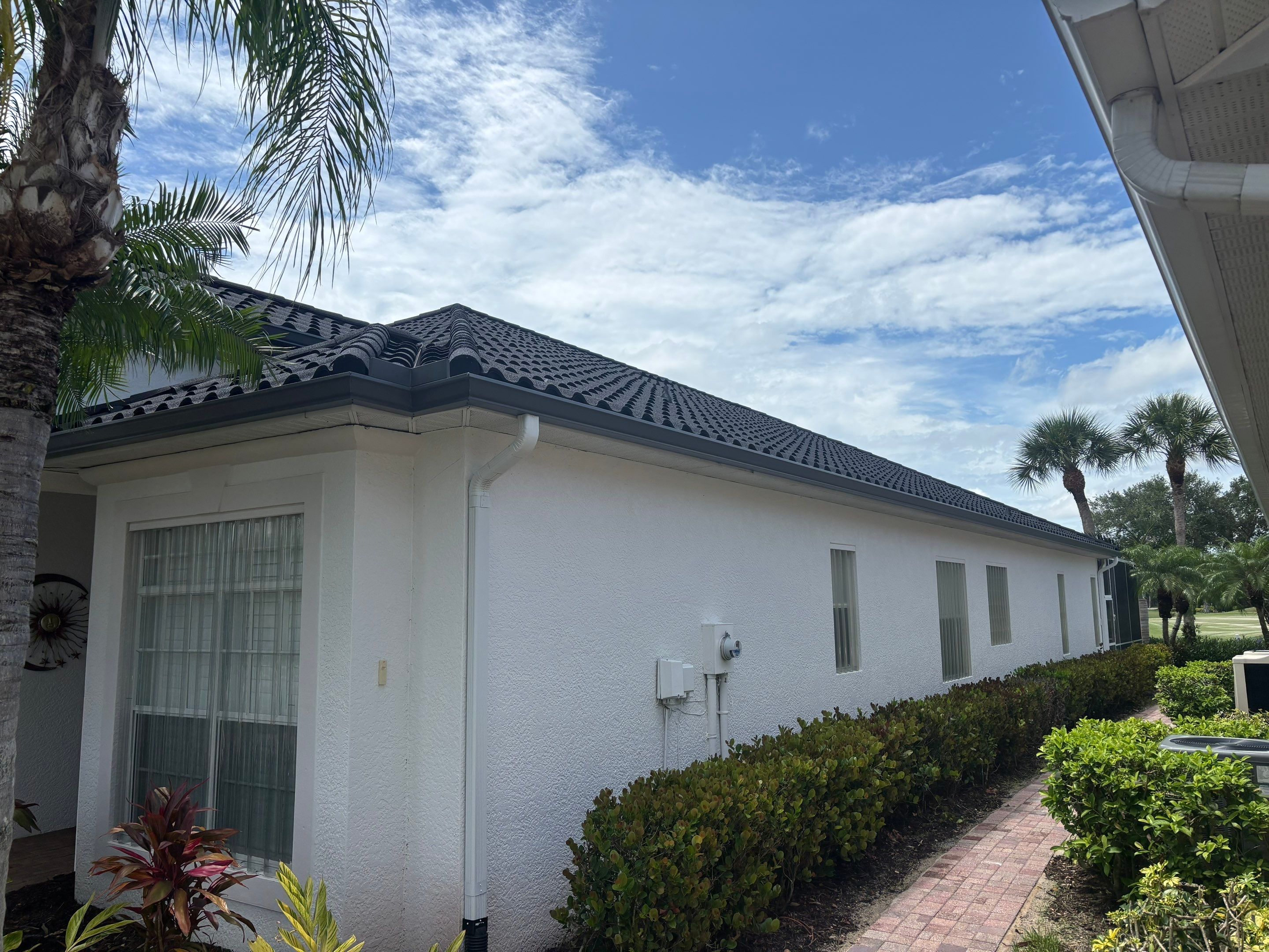 Large luxury house complex with premium roofing system aerial perspective