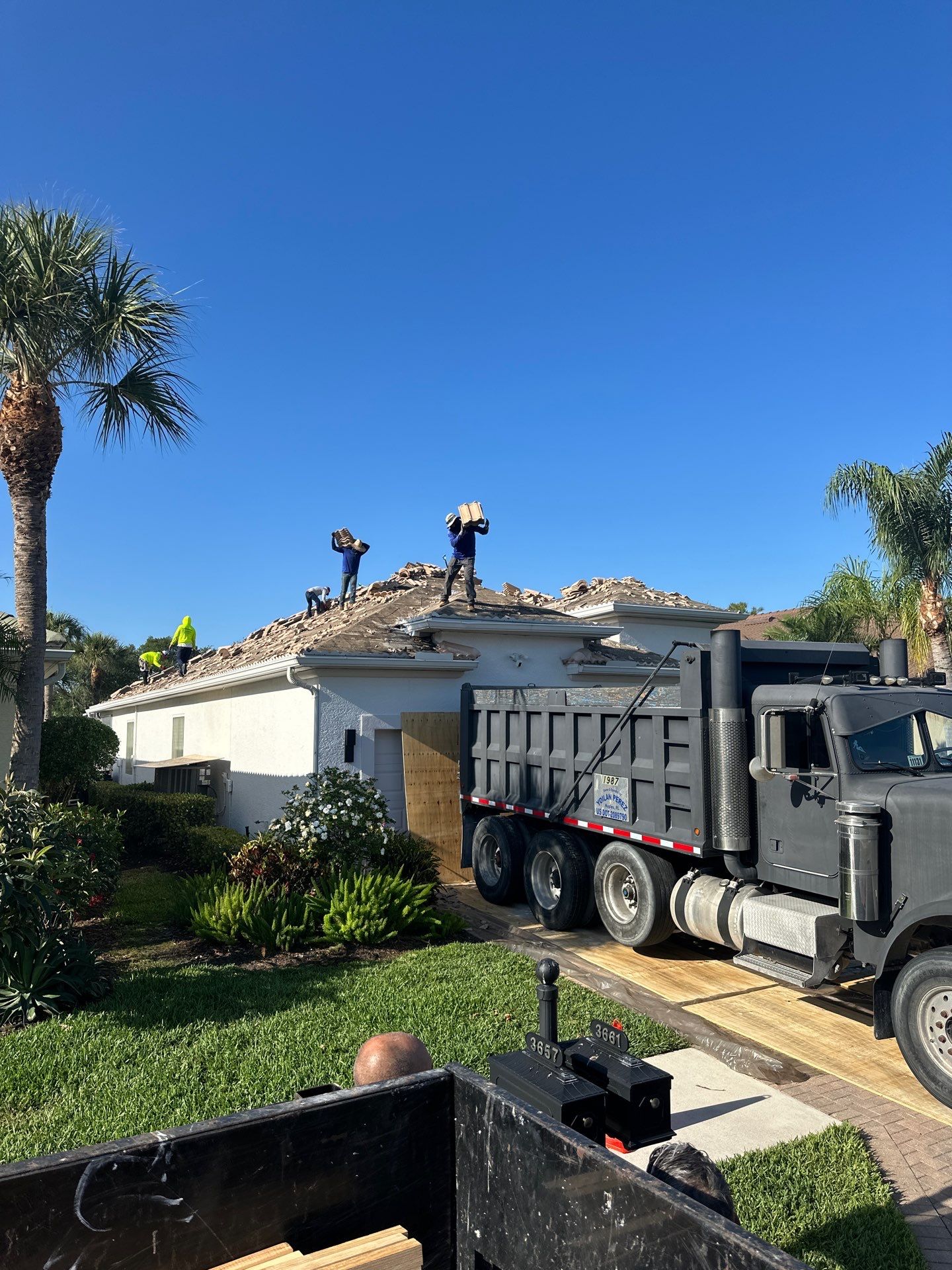 Aerial view showing various residential roof types and materials
