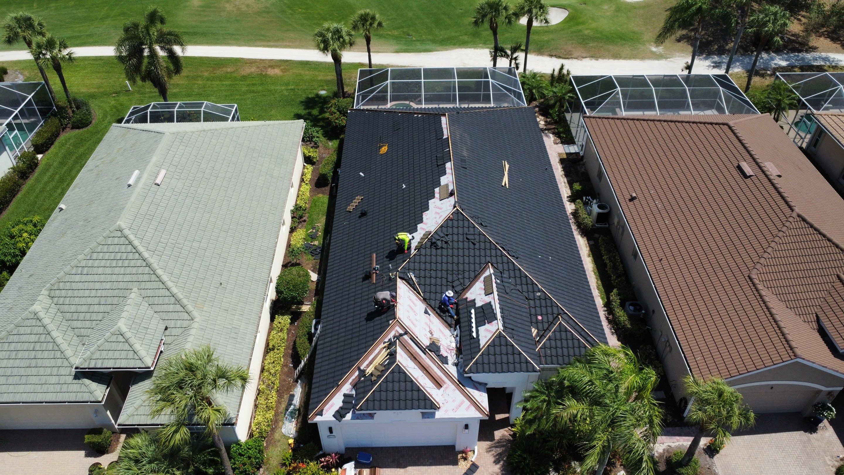 Active roofing construction project aerial view showing professional work in progress