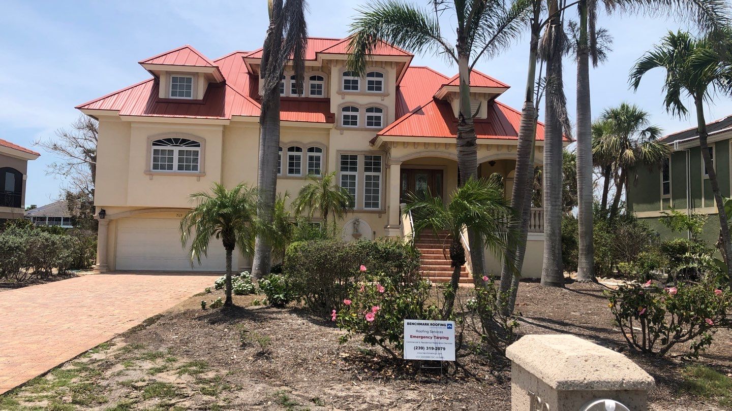 Red metal roof completion showing metal roofing expertise